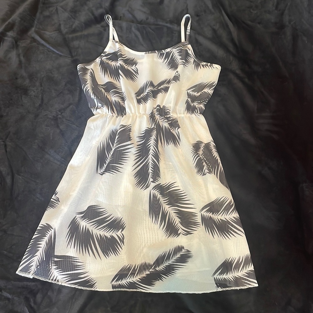 Brand is Shein and it’s white with black Pom leaves